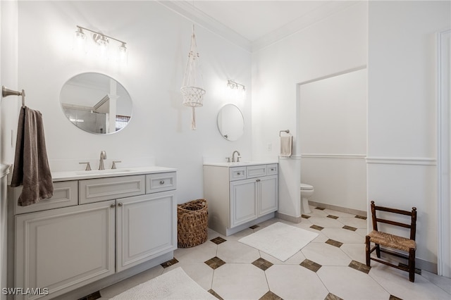 bathroom featuring crown molding, vanity, and toilet