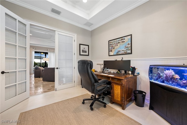 home office with a raised ceiling and crown molding