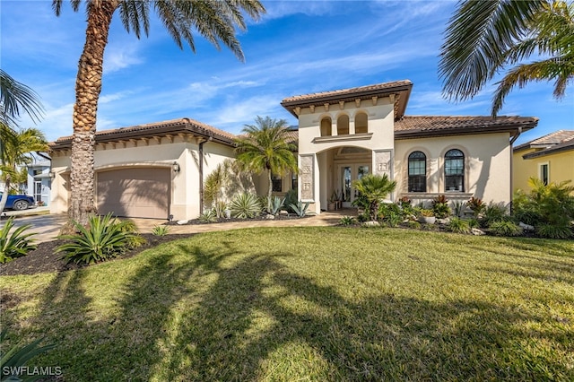 mediterranean / spanish-style house with a garage and a front yard