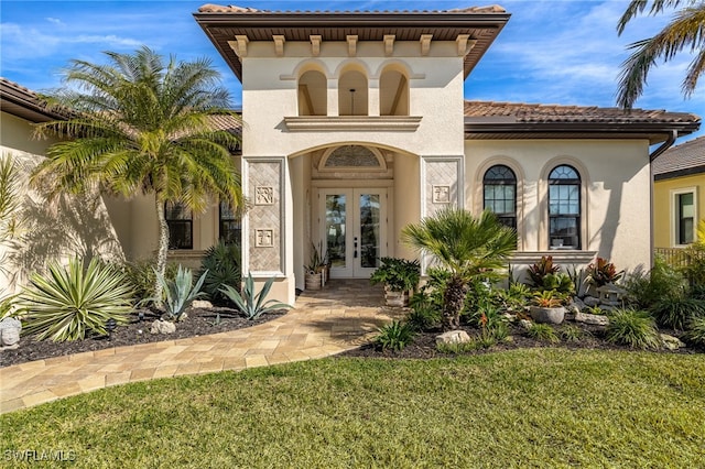 view of front facade featuring a front yard and french doors