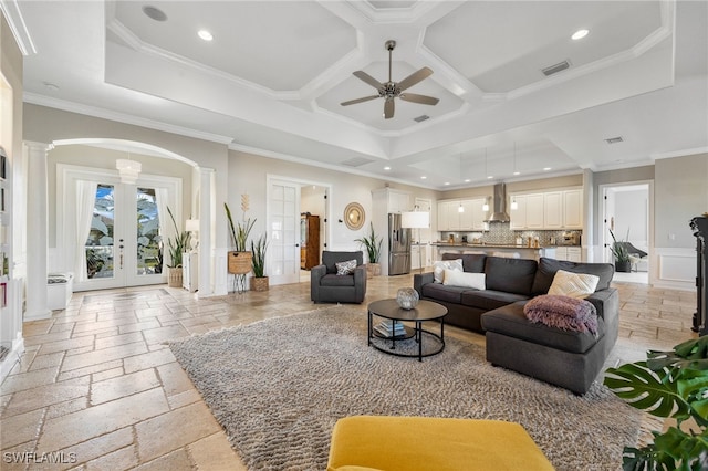 living room with ornate columns, ornamental molding, coffered ceiling, and french doors