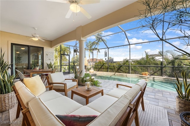 view of patio / terrace featuring an outdoor hangout area, ceiling fan, and glass enclosure