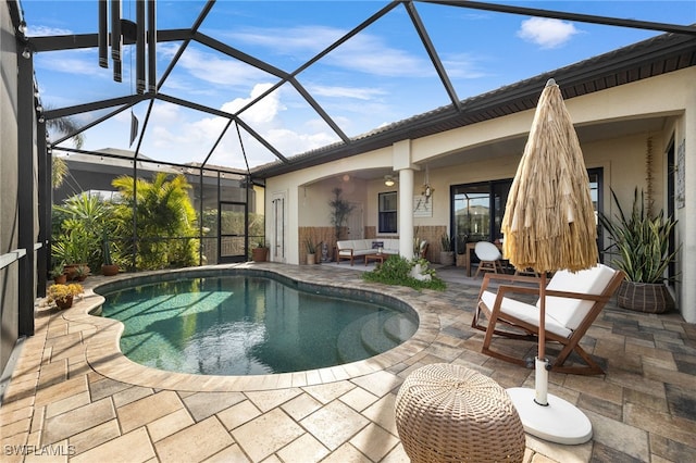 view of pool featuring ceiling fan, a lanai, and a patio area