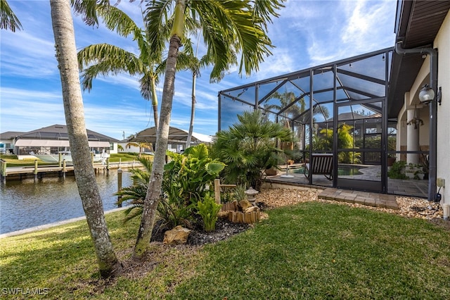 view of yard featuring a water view and glass enclosure