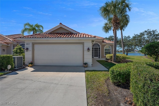 mediterranean / spanish-style home with a garage