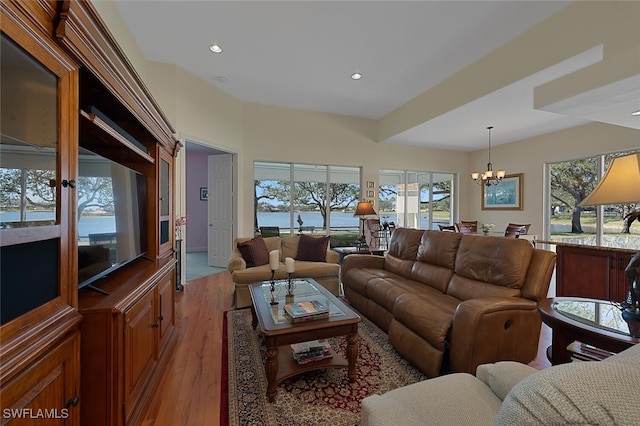 living room featuring a chandelier and light hardwood / wood-style floors