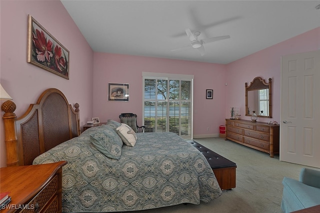 carpeted bedroom featuring multiple windows, ceiling fan, and baseboards