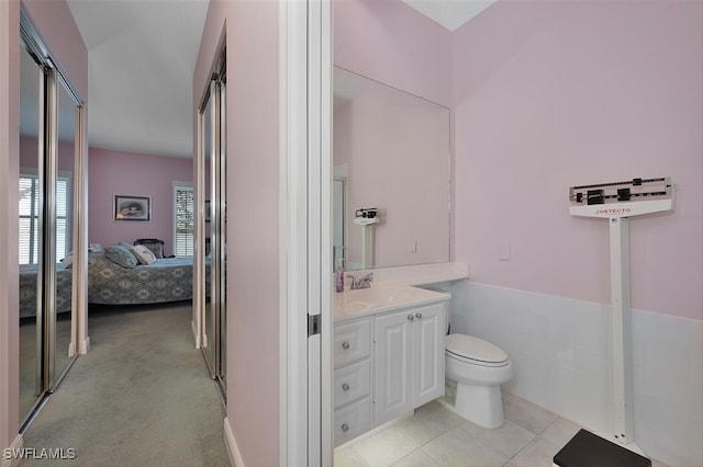 bathroom featuring ensuite bath, toilet, tile patterned flooring, and vanity