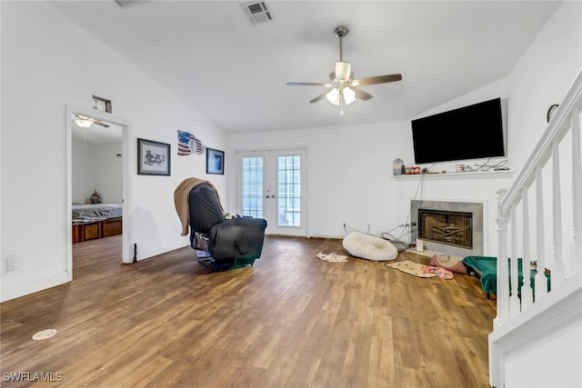 living area with hardwood / wood-style flooring, lofted ceiling, ceiling fan, and french doors