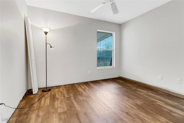 spare room featuring wood-type flooring and ceiling fan