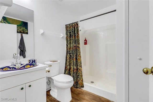 bathroom with hardwood / wood-style flooring, toilet, vanity, and a shower with shower curtain