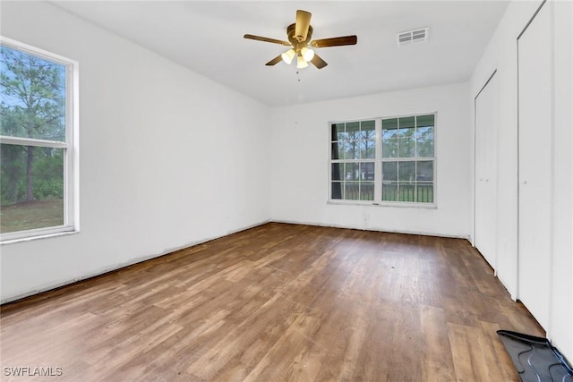 spare room featuring wood-type flooring and ceiling fan