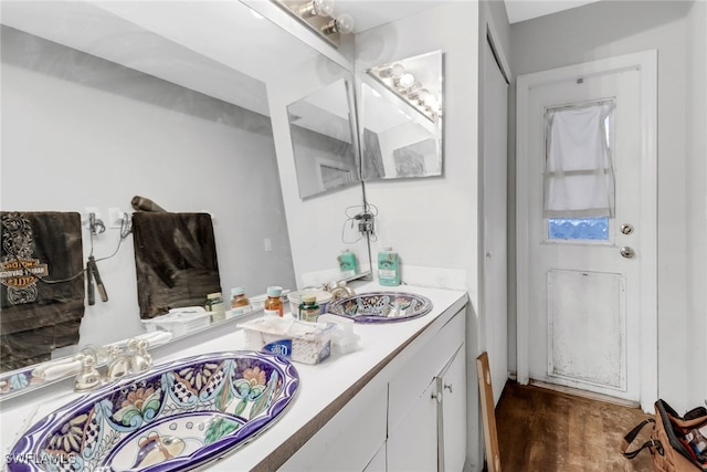 bathroom with hardwood / wood-style flooring and vanity