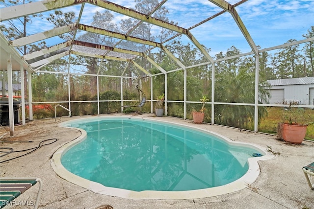 view of swimming pool featuring a lanai and a patio area