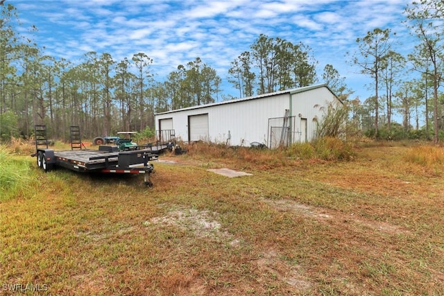 view of yard with a garage and an outdoor structure