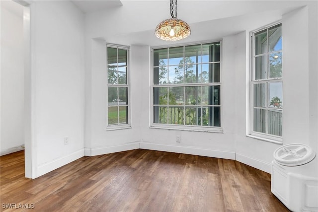 unfurnished dining area featuring dark hardwood / wood-style floors