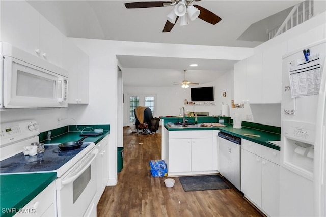 kitchen featuring sink, white appliances, white cabinets, dark hardwood / wood-style flooring, and kitchen peninsula