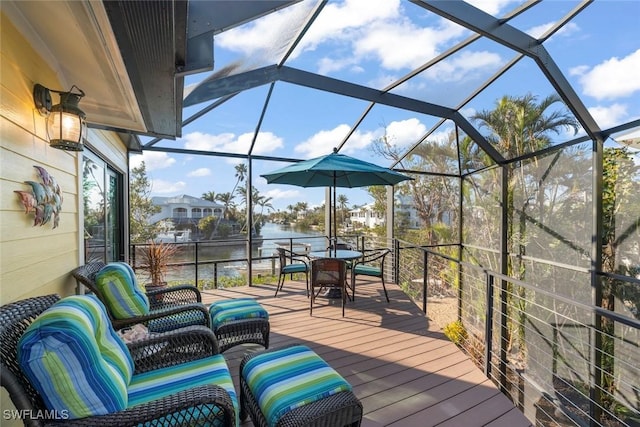 wooden terrace with an outdoor hangout area, glass enclosure, outdoor dining space, and a water view