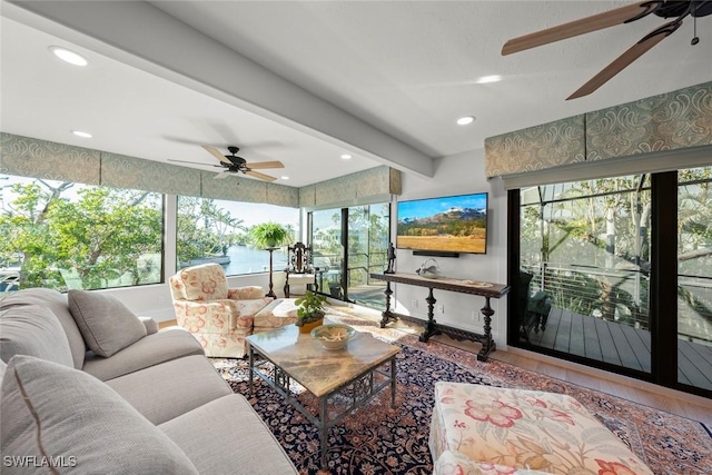 living area featuring a ceiling fan, beamed ceiling, and recessed lighting