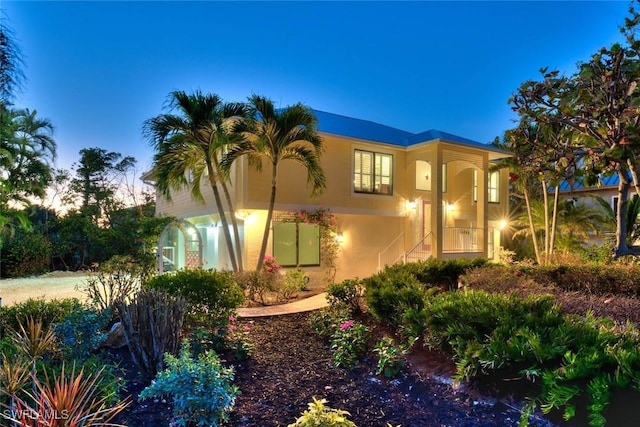 property exterior at dusk with stucco siding