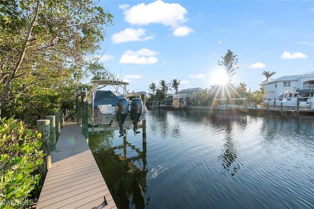 view of dock featuring a water view and boat lift