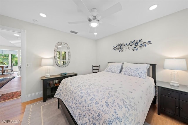 bedroom with light wood-style flooring, visible vents, baseboards, and recessed lighting