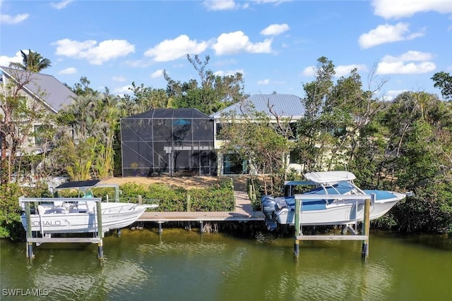 view of dock with glass enclosure, a water view, and boat lift