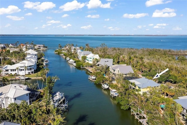 drone / aerial view with a water view and a residential view