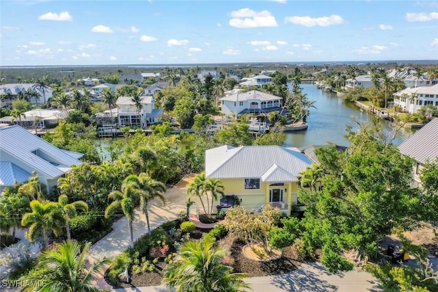 drone / aerial view with a water view and a residential view