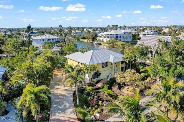 drone / aerial view featuring a residential view and a water view