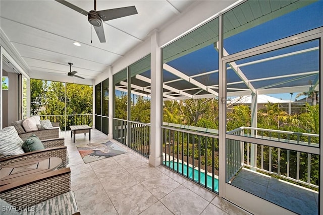 sunroom / solarium featuring ceiling fan