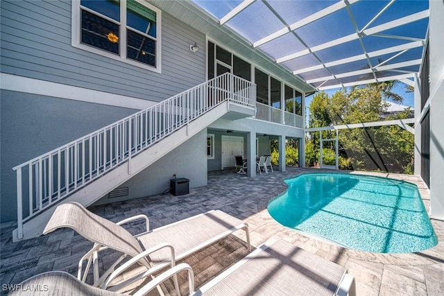 view of swimming pool featuring cooling unit and a patio