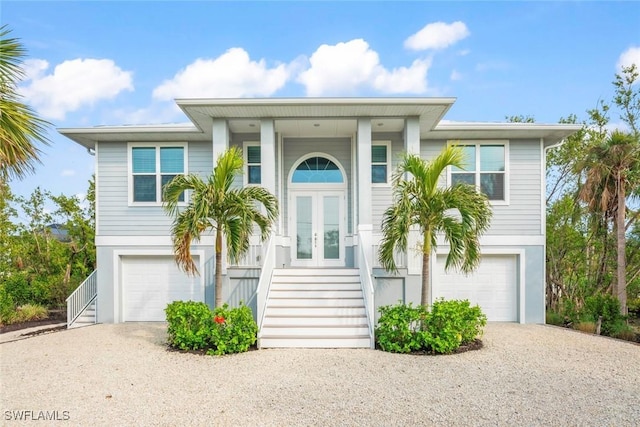 view of front of house with a garage and french doors