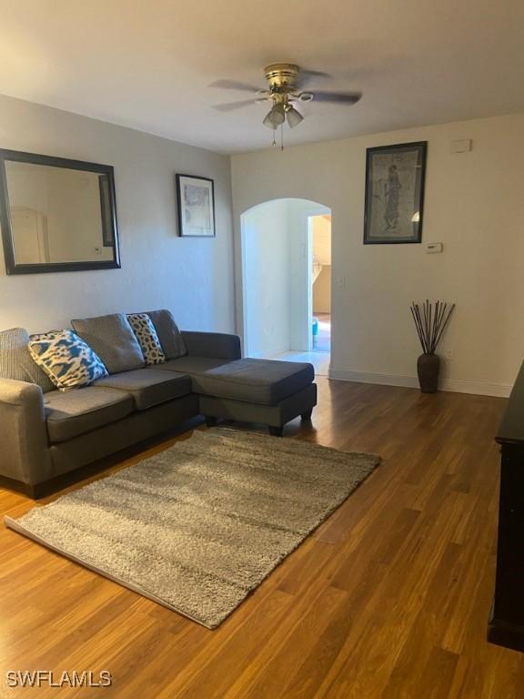 living room with ceiling fan and hardwood / wood-style flooring