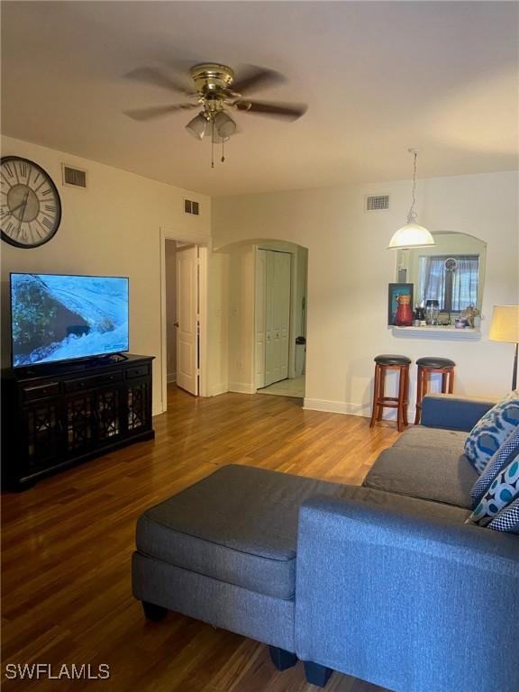 living room with ceiling fan and hardwood / wood-style flooring