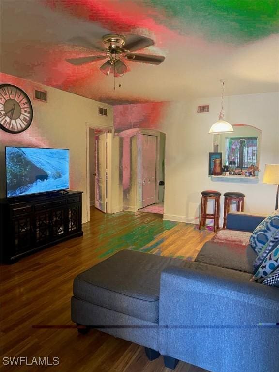 living room featuring ceiling fan and hardwood / wood-style floors