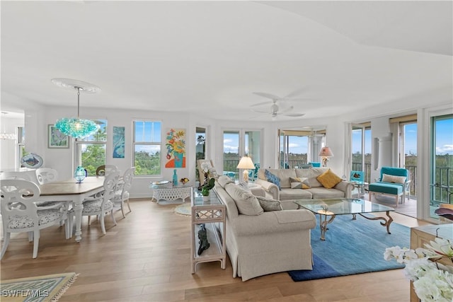 living room featuring ceiling fan and light hardwood / wood-style floors