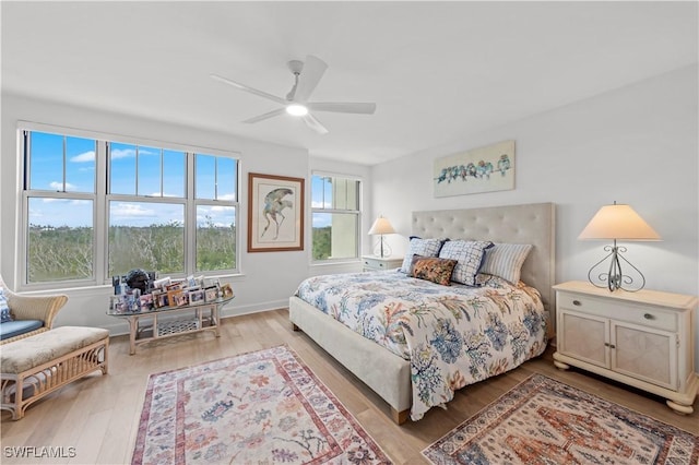 bedroom with ceiling fan and light hardwood / wood-style floors