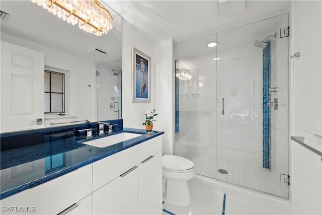 bathroom with a shower with shower door, tile patterned floors, vanity, and toilet