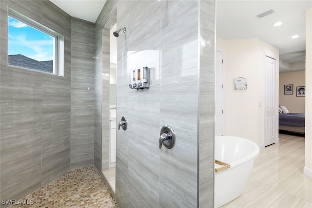 bathroom featuring separate shower and tub