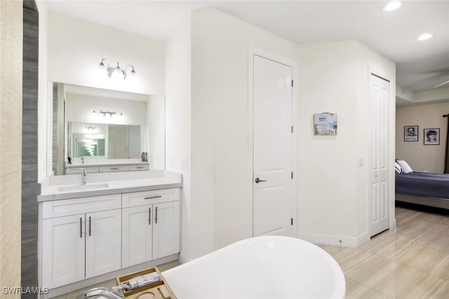 bathroom with vanity and a tub to relax in