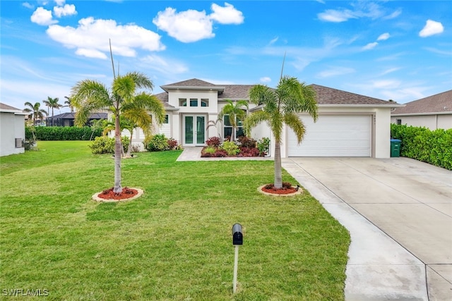 view of front of house featuring a garage, a front lawn, and french doors