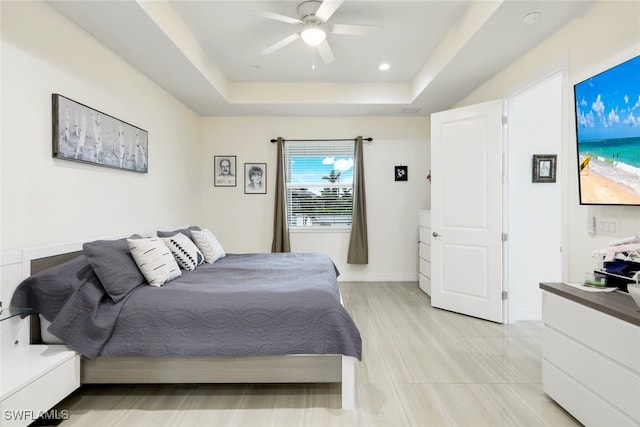 bedroom featuring a tray ceiling and ceiling fan