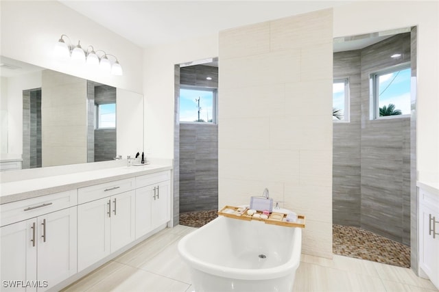 bathroom featuring tile patterned flooring, vanity, plenty of natural light, and shower with separate bathtub