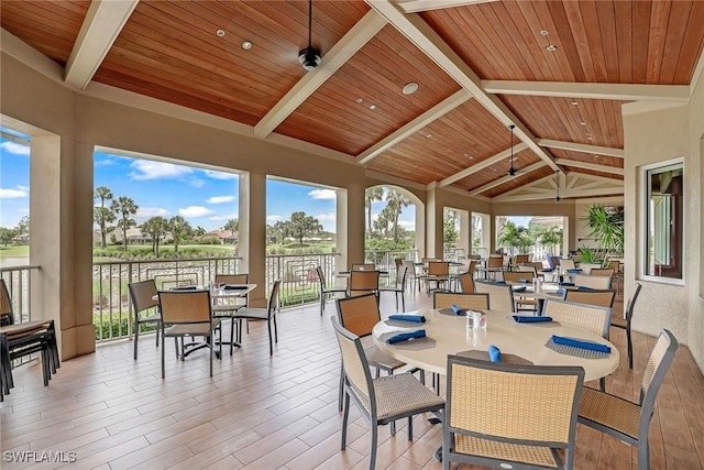 sunroom featuring vaulted ceiling with beams and wooden ceiling