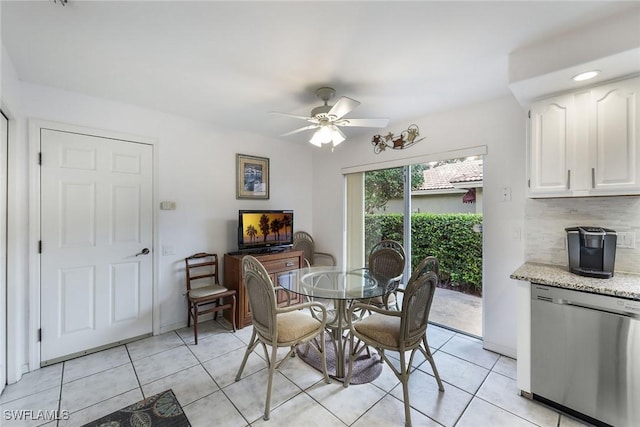 dining space featuring ceiling fan and light tile patterned floors