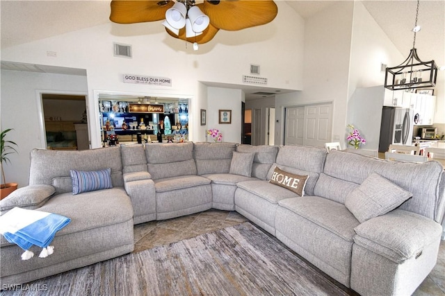 living room with ceiling fan and high vaulted ceiling