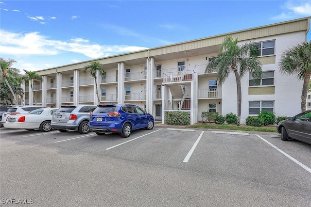 view of building exterior with uncovered parking