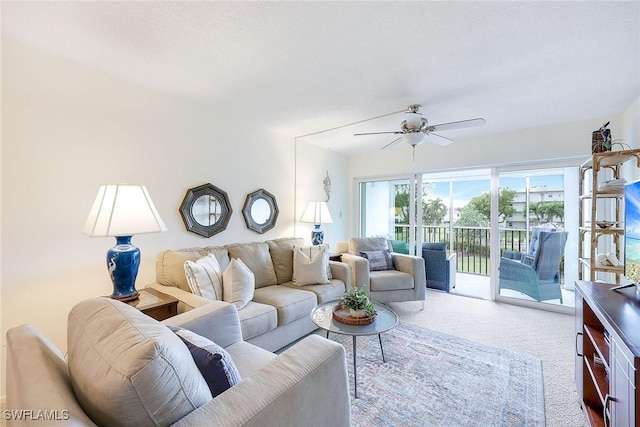 carpeted living room with ceiling fan