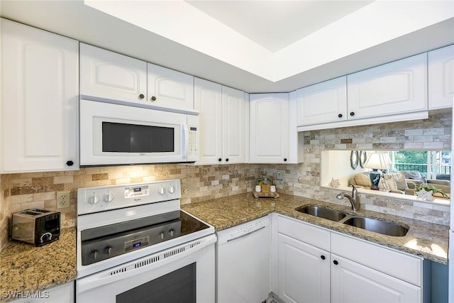 kitchen featuring sink, white cabinetry, white appliances, and stone countertops